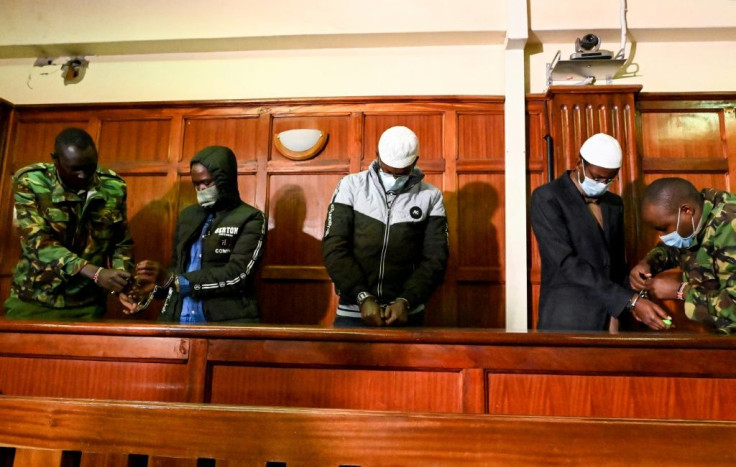 Defendants Hassan Hussein Mustafa (left), Liban Abdullahi Omar (centre) and Mohamed Ahmed Abdi (right) have their handcuffs removed for Wednesday's verdict