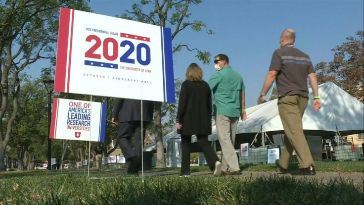 People stroll around the University of Utah campus in Salt Lake City on October 7, 2020, where police officers are watching the scene before the start of the vice-presidential debate between Mike Pence and Kamala Harris