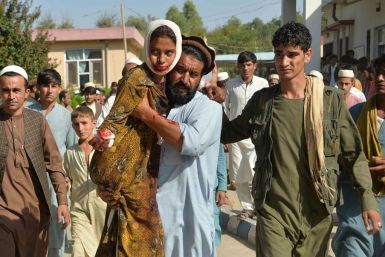 An injured youth is carried to a hospital following a car bomb attack that targeted a government building in the Ghani Khel district of Nangarhar province in Afghanistan on October 3, 2020