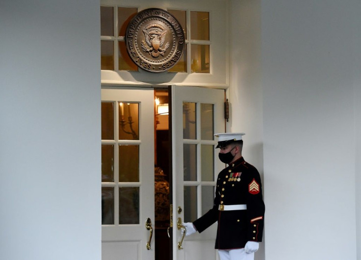 A US Marine wearing a facemask stands guard outside the West Wing, where President Donald Trump has appeared to be sending out a day-long flurry of tweets as he recovers from Covid-19