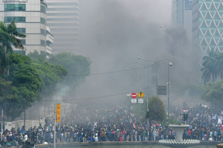 Smoke rises from fires set by activists during protests in Jakarta