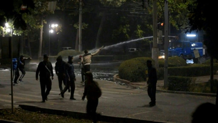 Riot police in Kyrgyzstan's capital Bishkek use water cannon, stun grenades and tear gas to disperse protesters at a rally against the results of a parliamentary vote.
