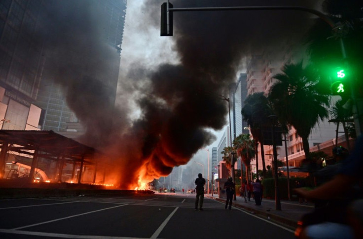 Smoke billows from a bus shelter set ablaze by protesters in Jakarta