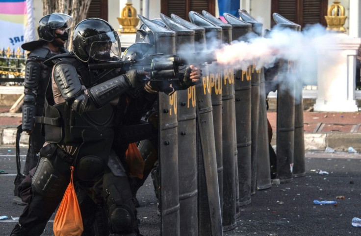 Riot police fire tear gas at protesters in Surabaya