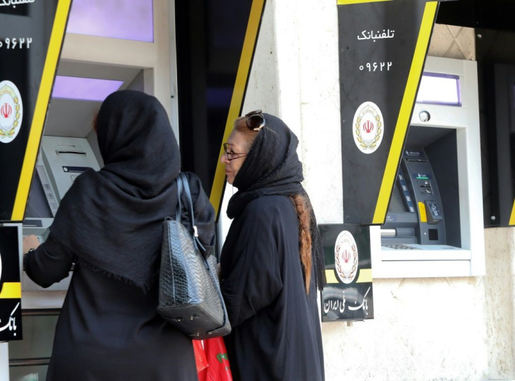 Iranian women use automated teller machines in Tehran in 2019