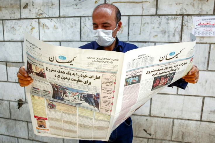 A man, clad in mask due to Covid-19 coronavirus pandemic, reads a copy of the Kayhan newspaper, considered to be the mouthpiece of ultraconservatives in Iran, in August 2020