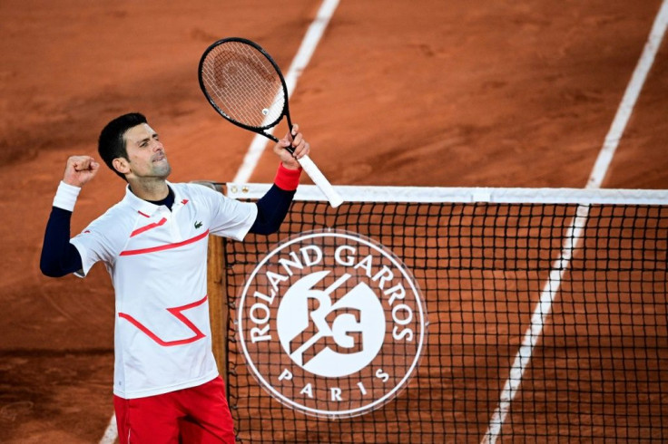 Marching on: Novak Djokovic celebrates after defeating Pablo Carreno Busta in the quarter-finals