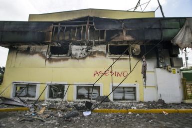 The building of Caruna, a Nicaraguan bank that has been hit by US sanctions over corruption allegations, is set on fire during 2018 protests in the capital Managua