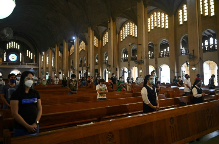Social distancing rules limit three people to pews that normally sit 10 and every second bench is left empty
