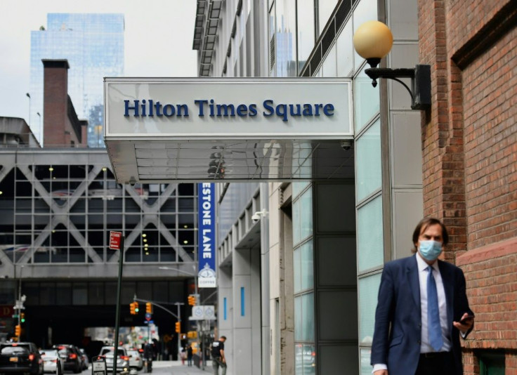 A pedestrian passes by New York's Hilton Times Square, which has closed due to the coronavirus pandemic