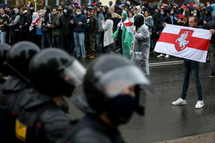 Many protesters carry the red-white-red flag that has become the symbol of the Belarusian opposition