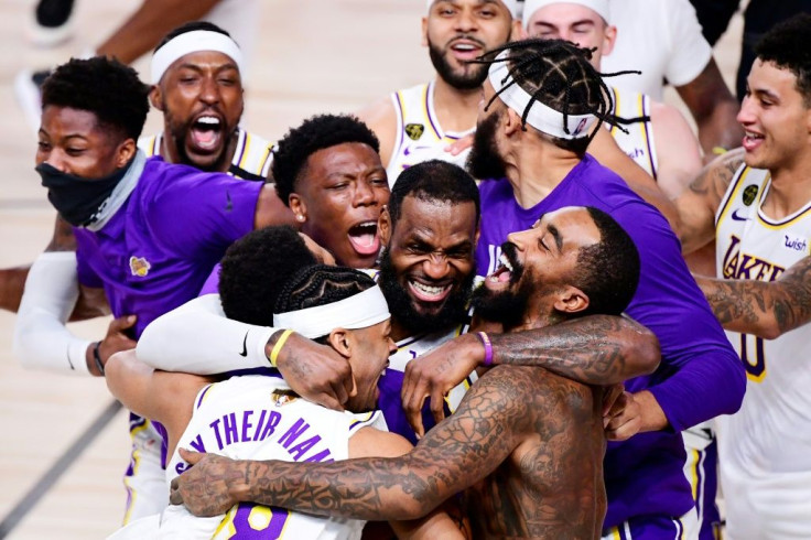 LeBron James celebrates with Los Angeles teammate Quinn Cook and others after the Lakers' championship-clinching 106-93 victory over the Miami Heat in game six of the NBA Finals