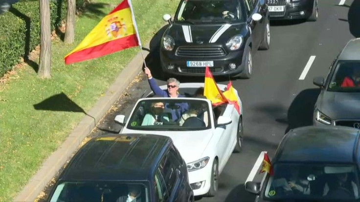 Protesters called out by the far-right party Vox drive through Madrid to protest the state of emergency the government imposed to fight a resurgence in the coronavirus
