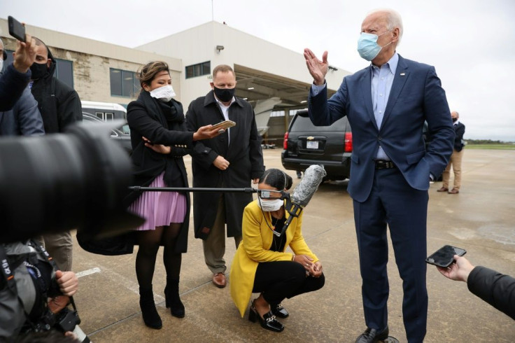 Democratic presidential nominee Joe Biden speaks to reporters before boarding a flight to Ohio