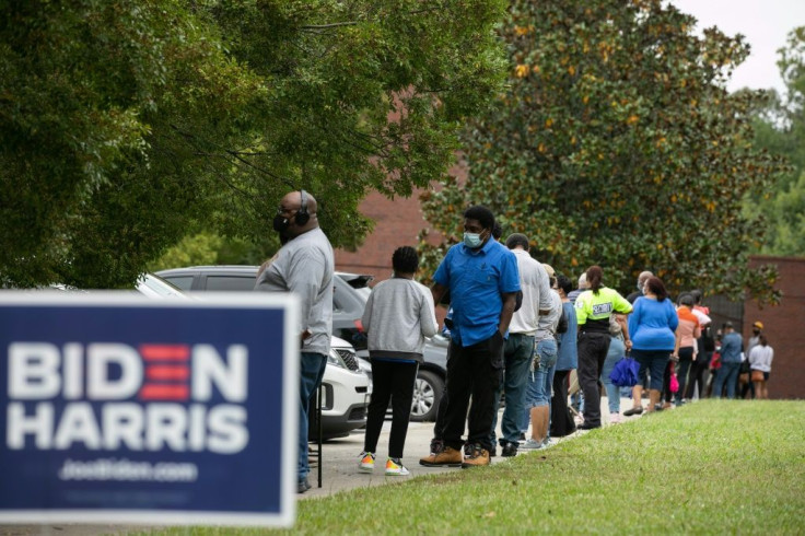People stand in line on the first day of early voting for the general election at the C.T. Martin Natatorium and Recreation Center on October 12, 2020 in Atlanta, Georgia