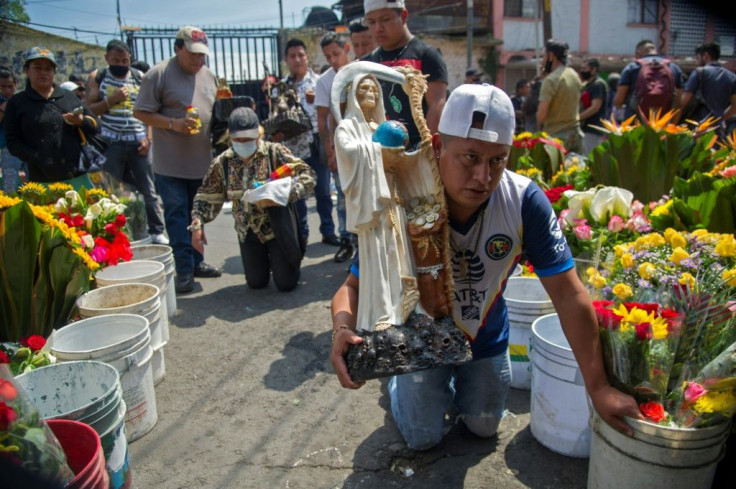 Some devotees arrive on their knees to worship at a shrine in Mexico City's Tepito neighborhood