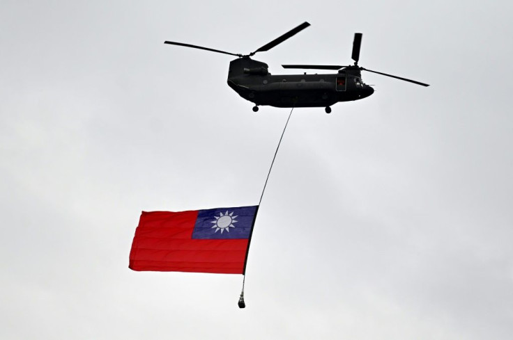 A military helicopter flies a Taiwan flag during a national day parade in Taipei on October 10. Beijing regards Taiwan as its own territory and has vowed to one day seize the self-ruled island