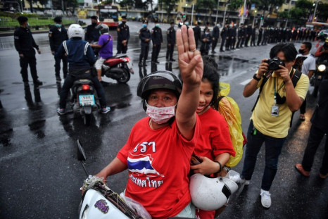 Some Thai protesters gave a three-fingered salute as a royal motorcvade passed by, a rare show of defiance