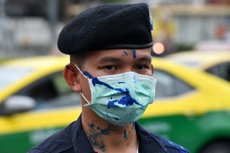 Some police were splattered with blue paint during the demonstration