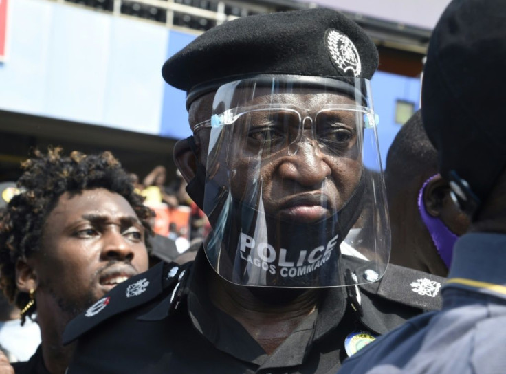 The police chief of Nigeria's economic hub looks on at protesters demonstrating against police brutality
