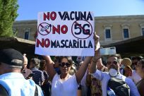 A woman protests "No vaccine, no 5G, no face mask" in Spain