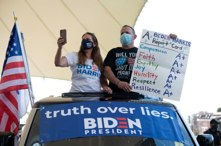 Supporters look on as Democratic Presidential Candidate Joe Biden speaks during a drive-in rally in Miramar, Florida