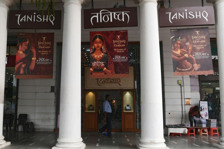 A man walks past a Tanishq jewellery showroom in New Delhi. The company has withdrawn an advert featuring an interfaith baby shower after a backlash by Hindu conservatives