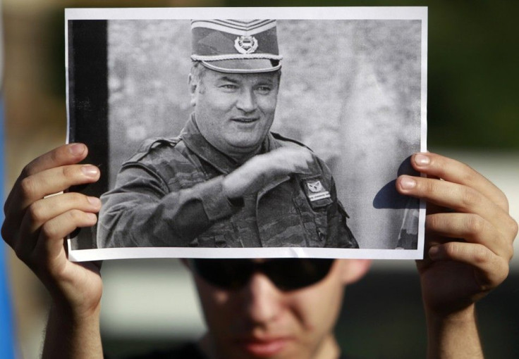 A participant holds a photo of former Bosnian Serb military commander Ratko Mladic during a rally to protest against the arrest of Mladic in front of the Serbian embassy in Moscow