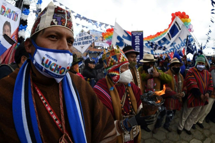 Supporters of Bolivian presidential candidate Luis Arce of the Movimiento Al Socialismo (MAS) take part in a rally in El Alto, Bolivia on October 14, 2020, ahead of general elections