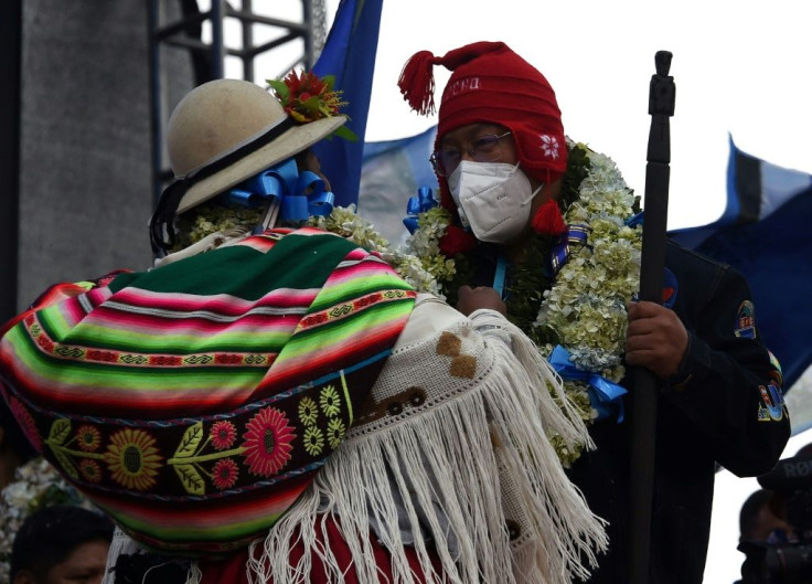 Leftist presidential candidate Luis Arce dances with an indigenous woman during the closing rally of his campaign in El Alto, Bolivia