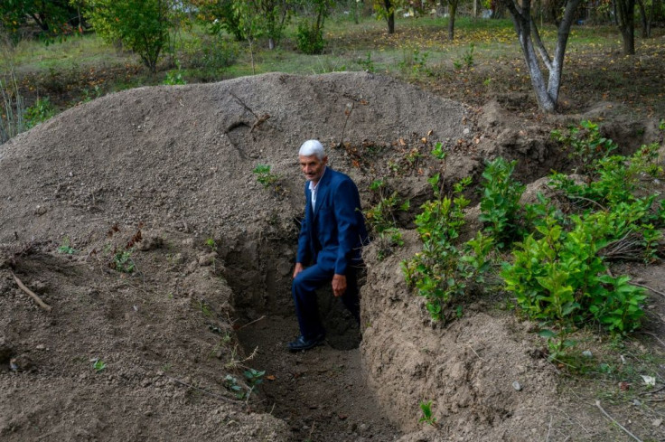 People in the frontier village of Bakharly take shelter from Armenian shells in trenches dug by Azerbaijani government officials