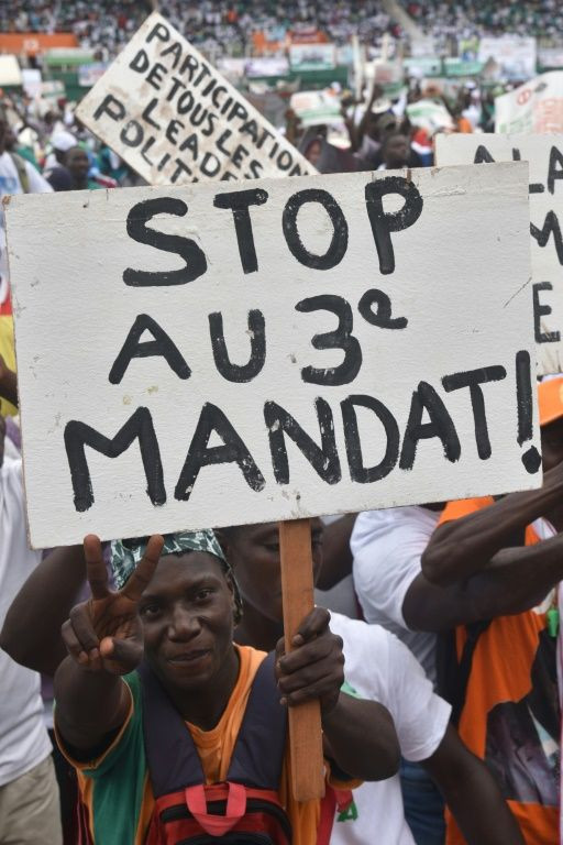 A man holds a placard reading "Stop to the third term"