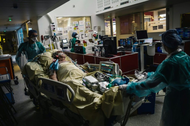 Medical staff transport a patient at the intensive care unit of Paris's Lariboisiere Hospital