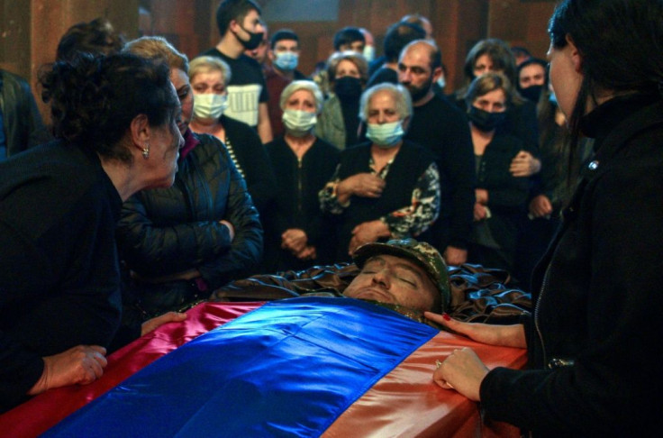 Relatives in the capital Yerevan mourn by the coffin of an Armenian soldier killed in the fighting between Armenia and Azerbaijan