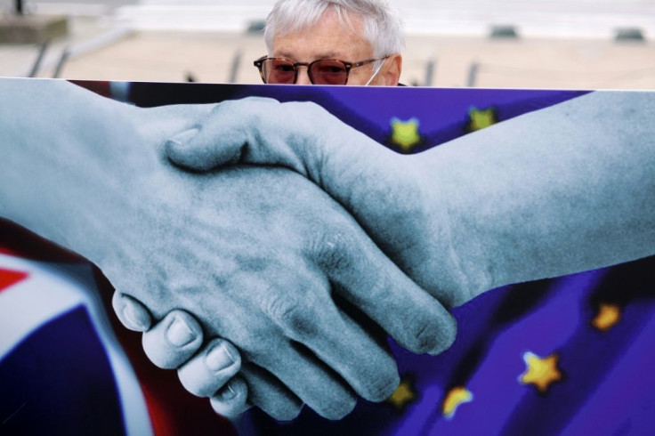 An anti-Brexit activist holds a placard to protest near the European Council Building prior to a two-day European Union (EU) summit in Brussels, on October 15, 2020