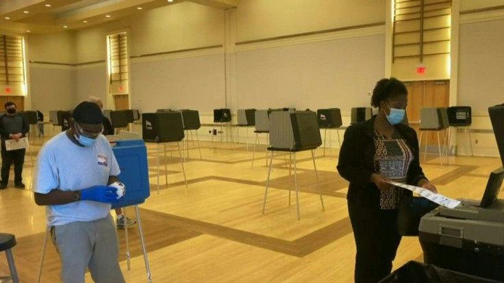 IMAGESPeople vote at a polling station in Raleigh as in-person early voting in the US presidential election starts in the battleground state of North Carolina.