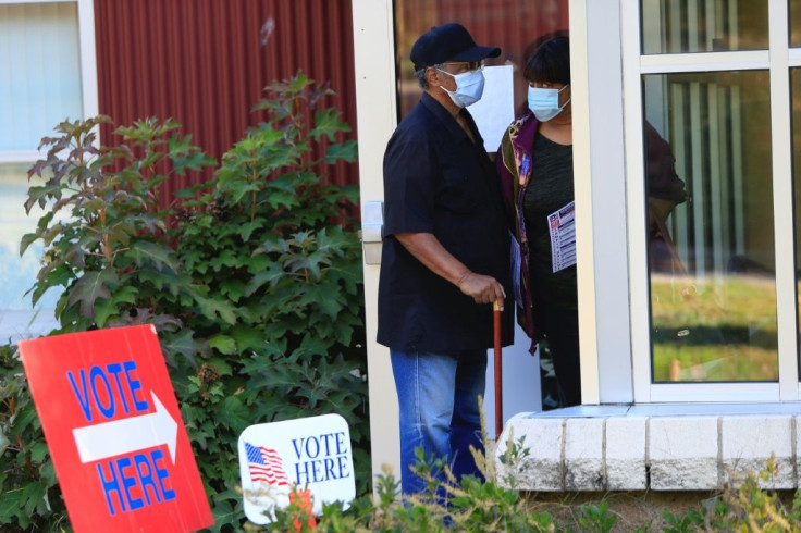 Voters wait in line to cast their ballots early in Asheville, North Carolina