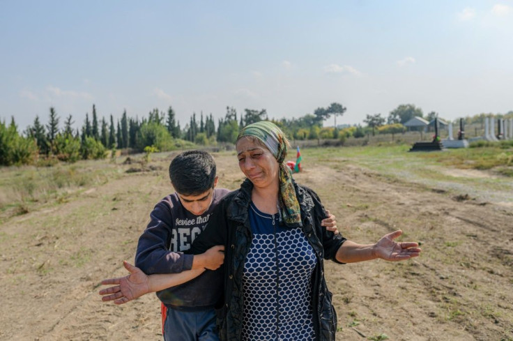 Aybeniz Khasanova cries next to the grave of her son, who died in fighting over Nagorno-Karabakh