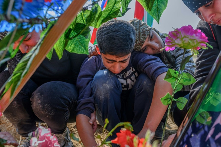 Family members of an Azerbaijani soldier grieve at his grave