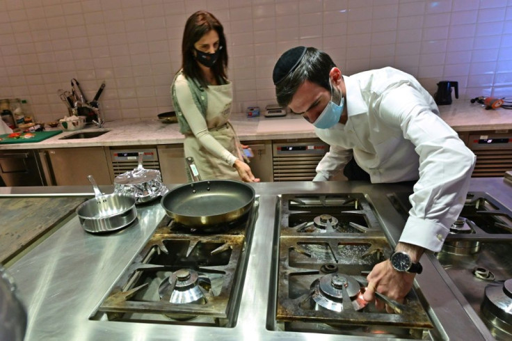 Rabbi Yaakov Eisenstein (R) supervises the preparation of food atElli's Kosher Kitchen, set up two years ago to enable Jewish travellers to remain observant while visiting the UAE