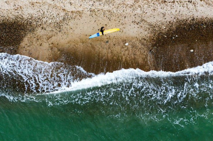 Surfers stranded by travel restrictions are seeking the perfect wave off the bleak coast of the Danish town of Klitmoller