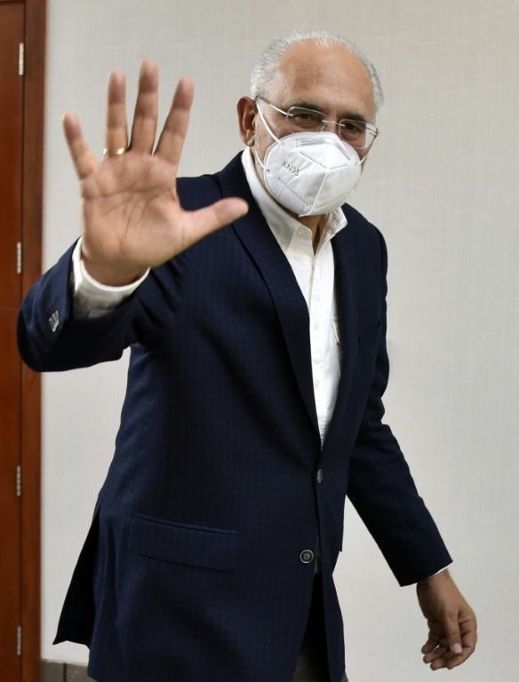 Bolivian presidential candidate Carlos Mesa waves after speaking to reporters in La Paz in October 2020