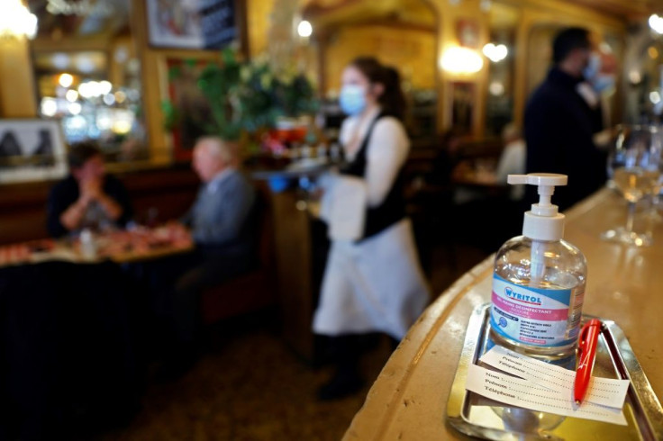 Hand sanitiser and client-registration tickets at a Paris restaurant this week, ahead of the new Covid-19 curfew.