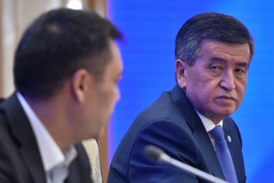 Kyrgyzstan's recently appointed Prime Minister Sadyr Japarov (L) and former president Sooronbay Jeenbekov (R) attend the Kyrgyz Parliament extraordinary meeting amid efforts to end a political crisis over a disputed October vote