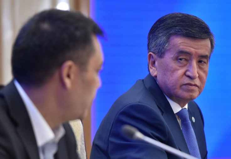 Kyrgyzstan's recently appointed Prime Minister Sadyr Japarov (L) and former president Sooronbay Jeenbekov (R) attend the Kyrgyz Parliament extraordinary meeting amid efforts to end a political crisis over a disputed October vote