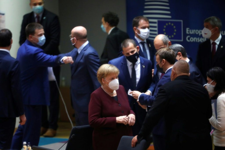 German Chancellor Angela Merkel (C) speaks with Bulgaria's Prime Minister Boyko Borissov (R) on the second day of a two-day EU summit in Brussels on Friday.