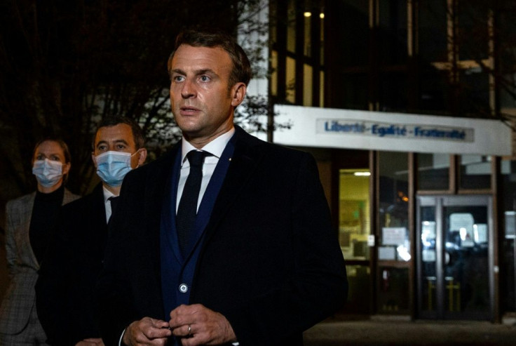 French President Emmanuel Macron, flanked by French Interior Minister Gerald Darmanin (second left) visited the scene of the murder and said it 'bore the hallmarks of "an Islamist terrorist attack'