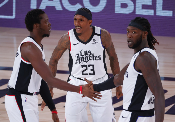 Reggie Jackson #1 of the LA Clippers celebrates a three point shot with teammates Lou Williams #23 and Montrezl Harrell #5 