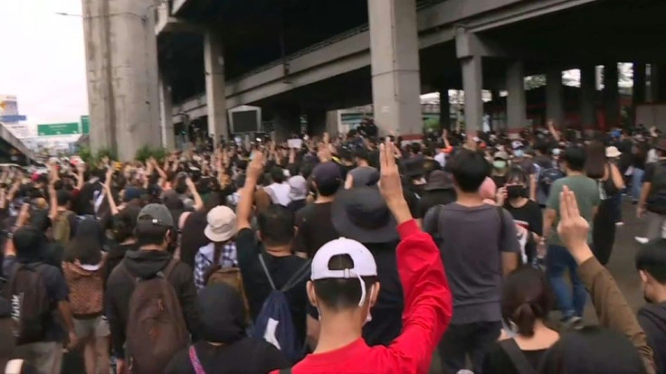 IMAGESPro-democracy protesters gather and show the three-fingered salute as they march in Bangkok on Saturday, defying an emergency decree banning gatherings after days of confrontations in the capital.