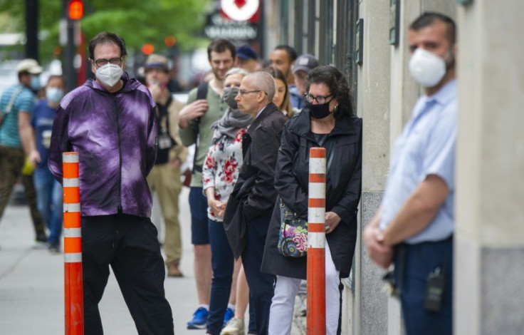 Restricted access -- customers queue outside the Simons store in Montreal